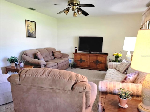 living room featuring light carpet and ceiling fan