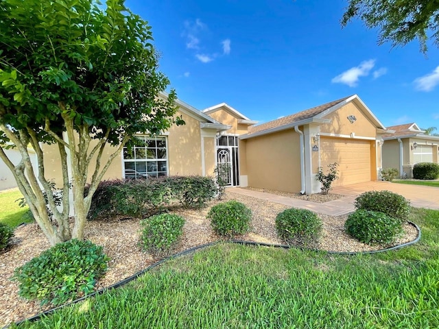 single story home featuring a garage and a front yard