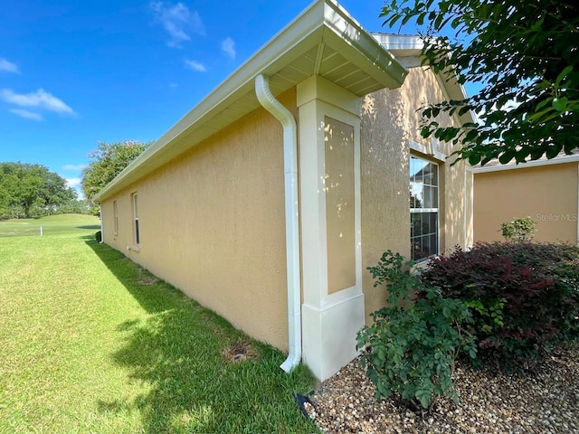 view of side of property with a lawn