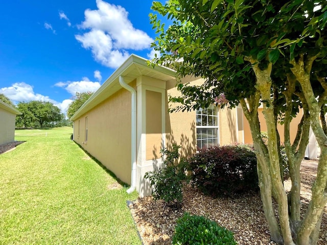 view of property exterior with a yard