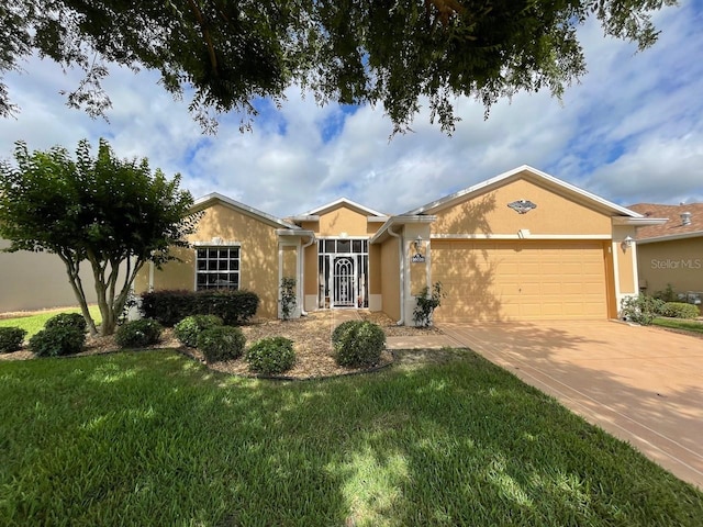 single story home featuring concrete driveway, a front yard, an attached garage, and stucco siding