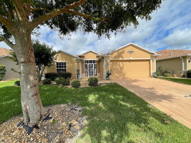 ranch-style house featuring a garage, a front yard, driveway, and stucco siding