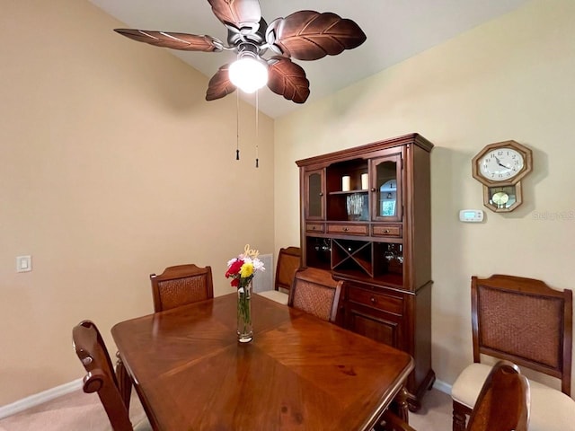 dining area with light carpet and ceiling fan