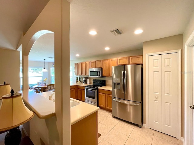 kitchen with appliances with stainless steel finishes and light tile patterned floors