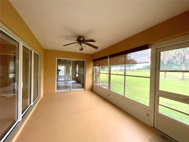 unfurnished sunroom with ceiling fan