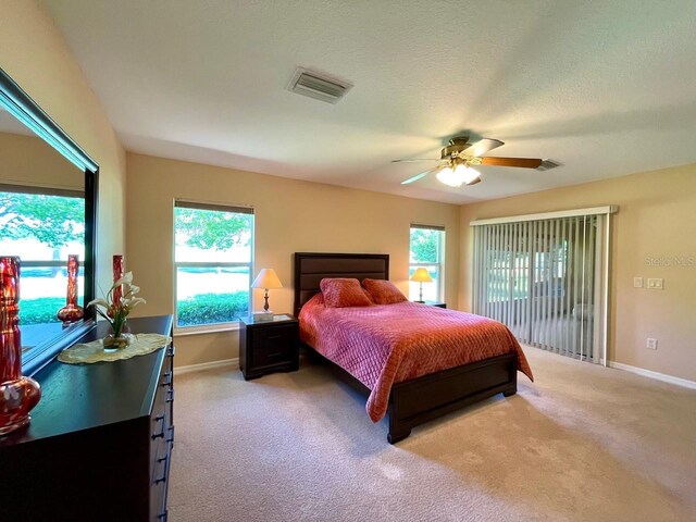 bedroom with access to outside, light carpet, a textured ceiling, and ceiling fan