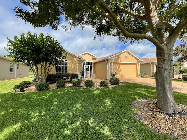 ranch-style home with concrete driveway, stucco siding, an attached garage, and a front yard