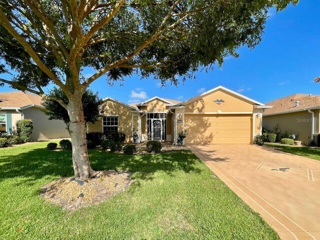 ranch-style home featuring an attached garage, driveway, a front lawn, and stucco siding