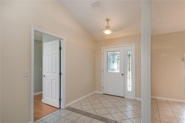 tiled foyer entrance featuring lofted ceiling