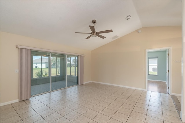 empty room with light tile floors, ceiling fan, and vaulted ceiling