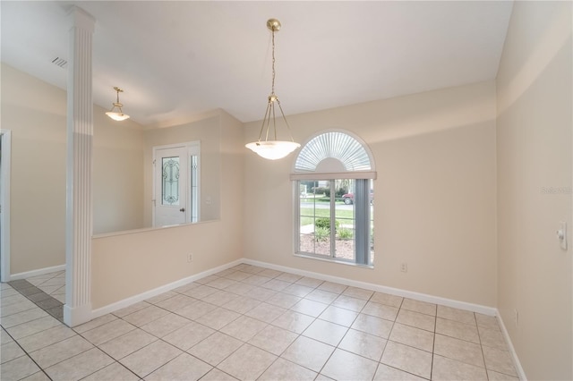 tiled spare room with decorative columns