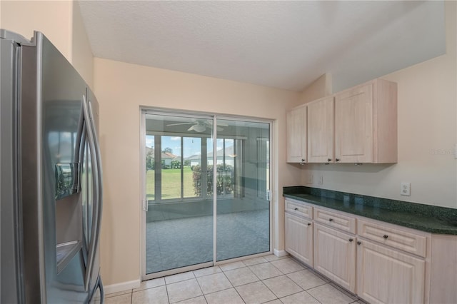 kitchen featuring ceiling fan, stainless steel fridge, light brown cabinetry, and light tile floors