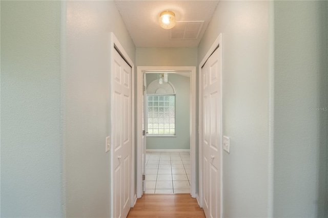 hallway featuring light tile floors