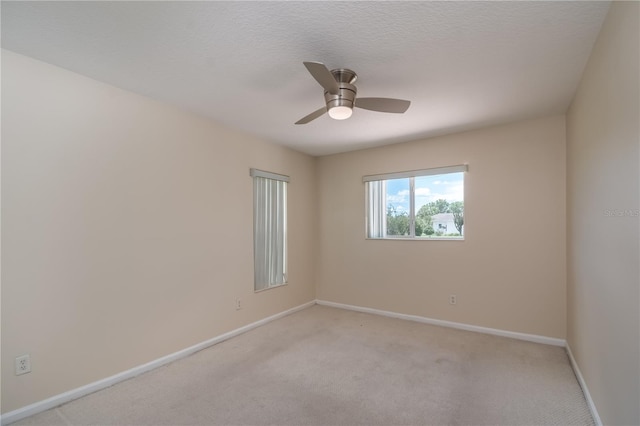 unfurnished room with ceiling fan and carpet floors