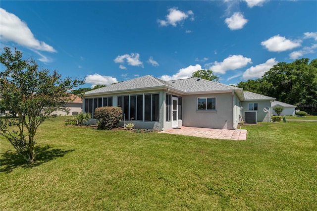 back of property featuring a yard, a sunroom, and a patio area