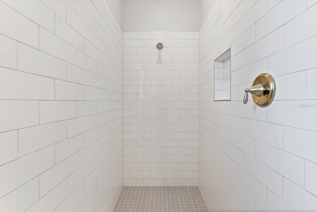 bathroom with tiled shower