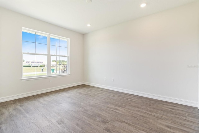 spare room with hardwood / wood-style floors