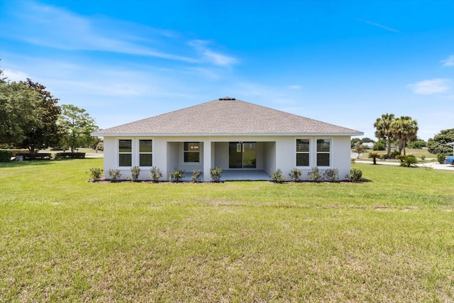 rear view of house with a lawn