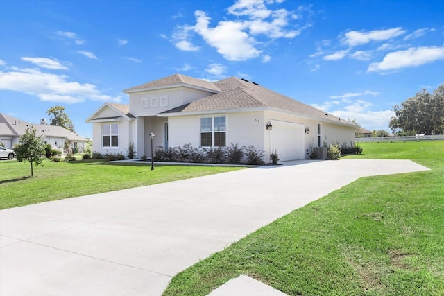 view of front of property with cooling unit, a garage, and a front yard