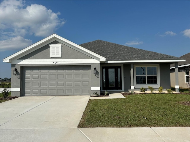 ranch-style house with a garage and a front yard