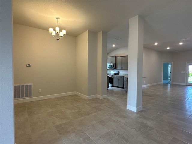 spare room featuring a chandelier