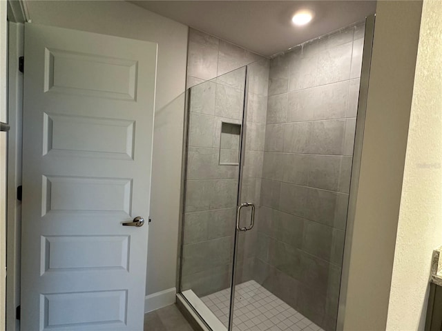 bathroom featuring a shower with shower door