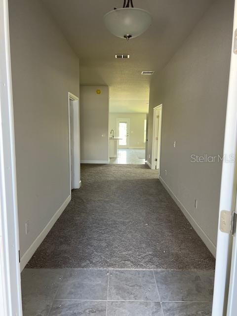 corridor with carpet flooring