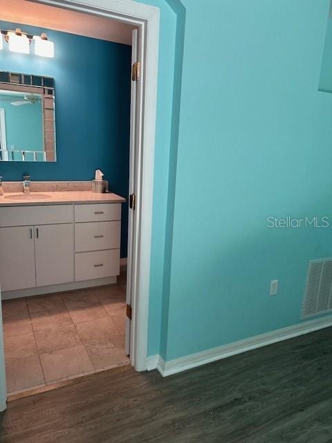 bathroom featuring vanity and wood-type flooring