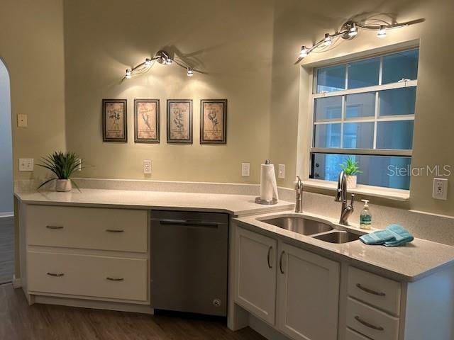 kitchen featuring dishwasher, sink, white cabinets, and dark hardwood / wood-style flooring