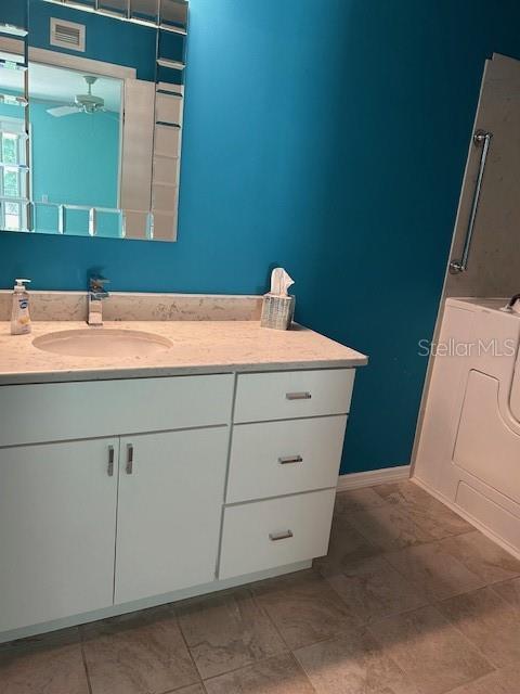 bathroom featuring vanity and ceiling fan