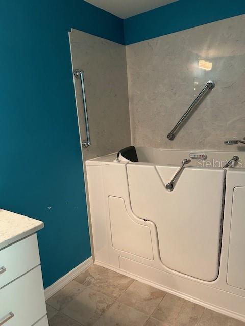 bathroom featuring vanity and a tub