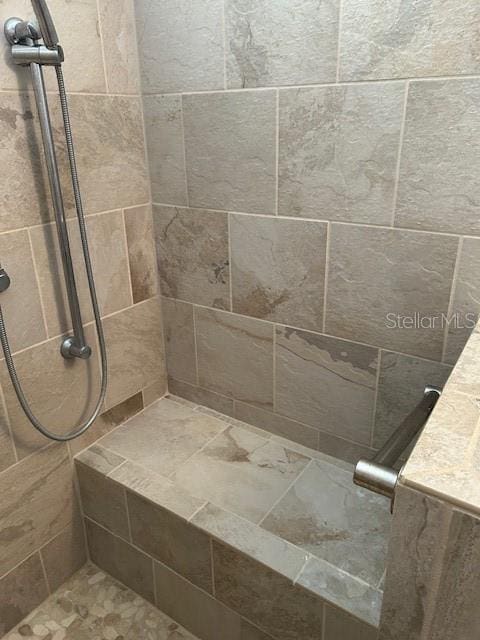 bathroom with tiled shower