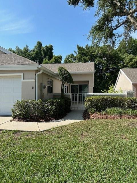 ranch-style home with a garage and a front yard