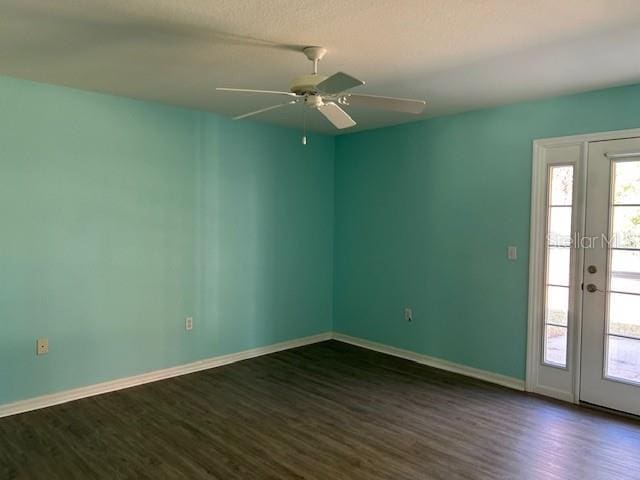 spare room featuring ceiling fan, dark hardwood / wood-style floors, and a textured ceiling