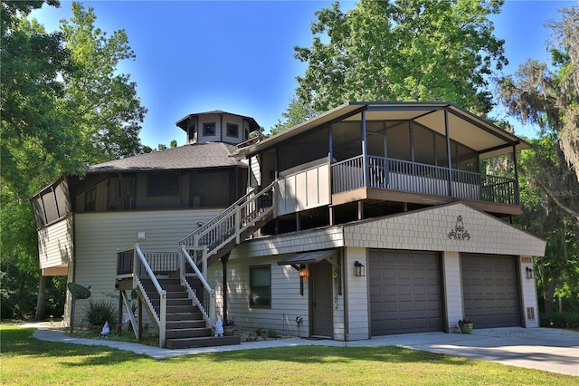 view of front facade featuring a sunroom, a garage, and a front lawn