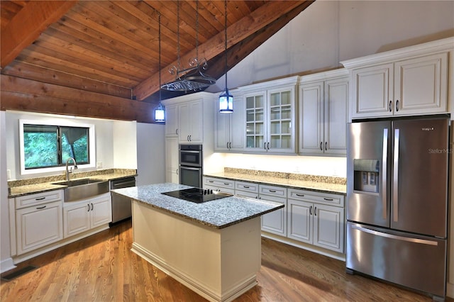 kitchen with appliances with stainless steel finishes, beam ceiling, wood-type flooring, sink, and wood ceiling