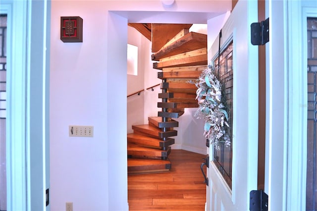 stairway featuring hardwood / wood-style floors