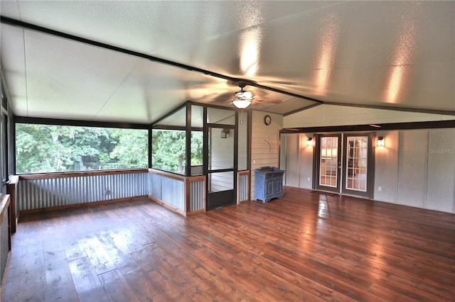 unfurnished living room featuring hardwood / wood-style flooring, plenty of natural light, ceiling fan, and vaulted ceiling