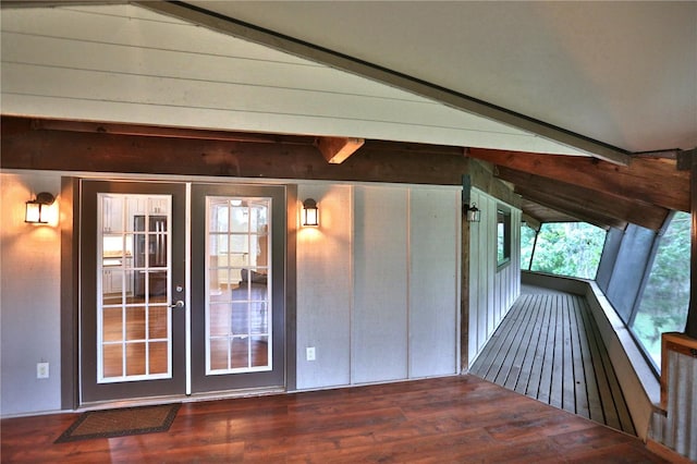 interior space with vaulted ceiling with skylight and french doors