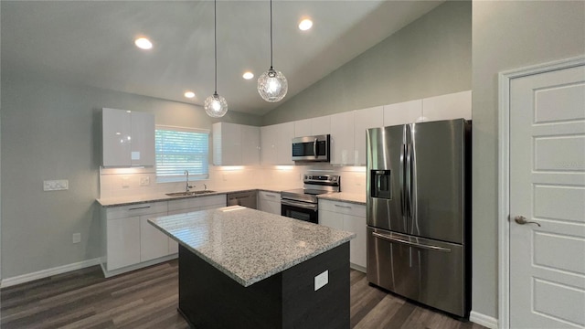 kitchen featuring dark hardwood / wood-style floors, a center island, stainless steel appliances, and tasteful backsplash