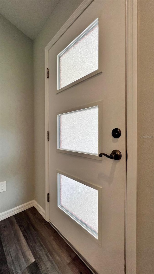 entryway with dark hardwood / wood-style flooring