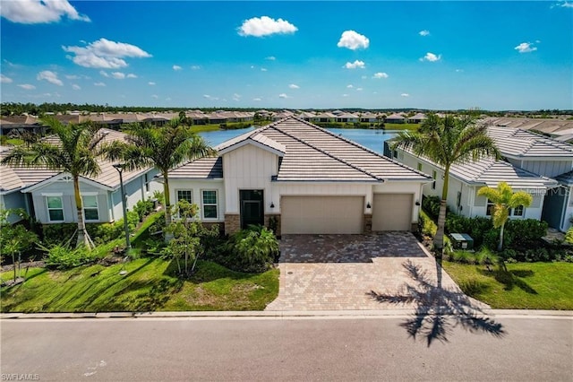 view of front of house featuring a water view and a garage