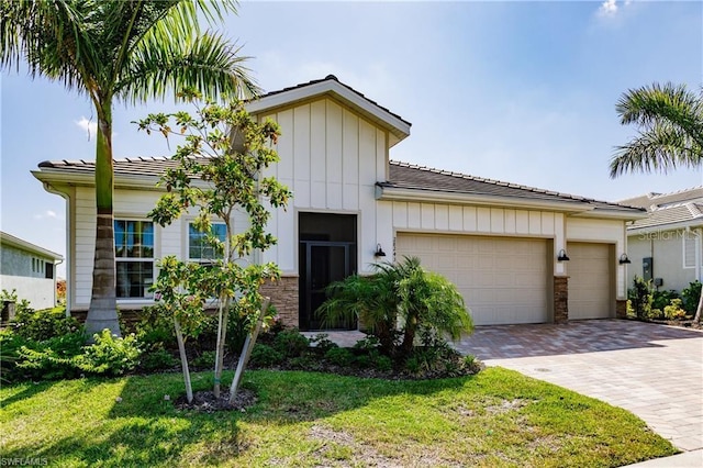 view of front of house with a garage and a front lawn