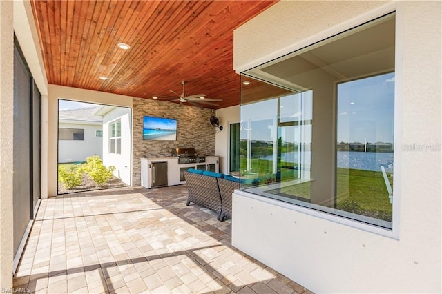 unfurnished sunroom with ceiling fan and wood ceiling