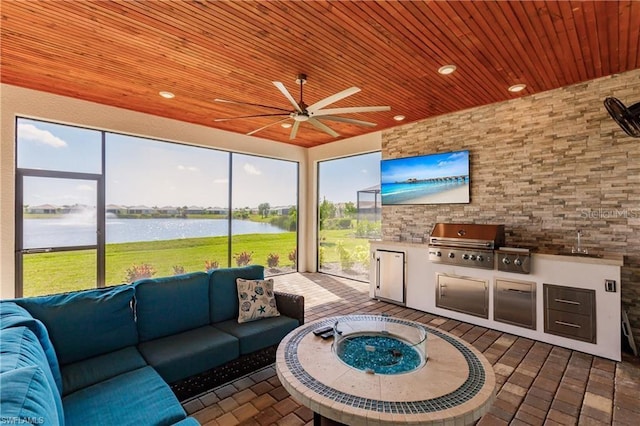 unfurnished sunroom featuring wooden ceiling, ceiling fan, and a water view