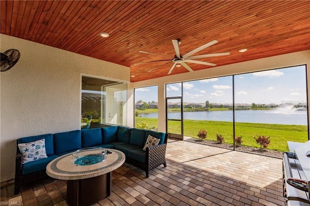 sunroom featuring a water view, ceiling fan, and wood ceiling