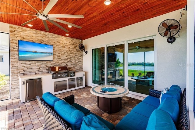 view of patio / terrace with ceiling fan, a water view, area for grilling, an outdoor hangout area, and a grill