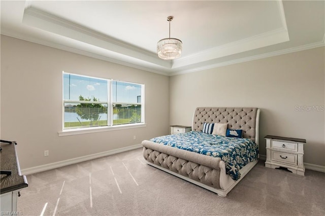 carpeted bedroom with ornamental molding, an inviting chandelier, and a raised ceiling