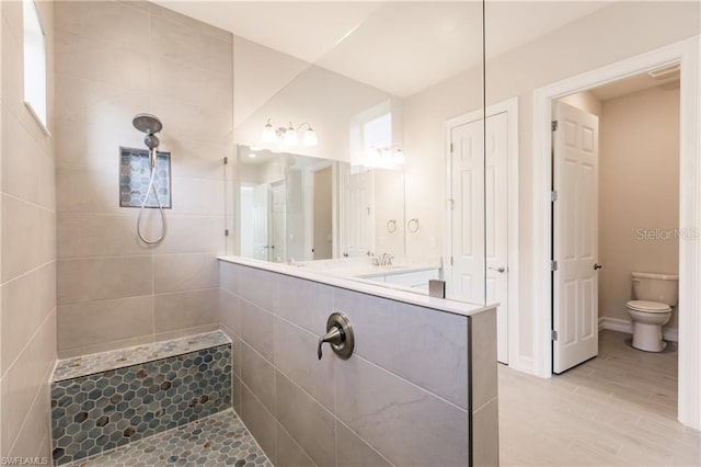 bathroom featuring tile floors, vanity, and toilet