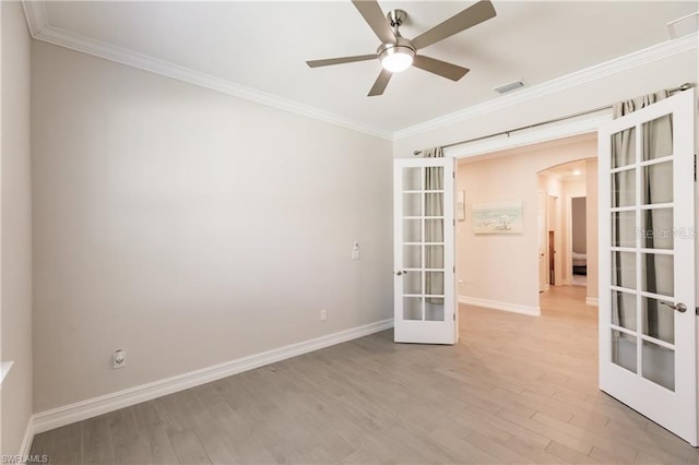 spare room with french doors, ornamental molding, ceiling fan, and light hardwood / wood-style flooring